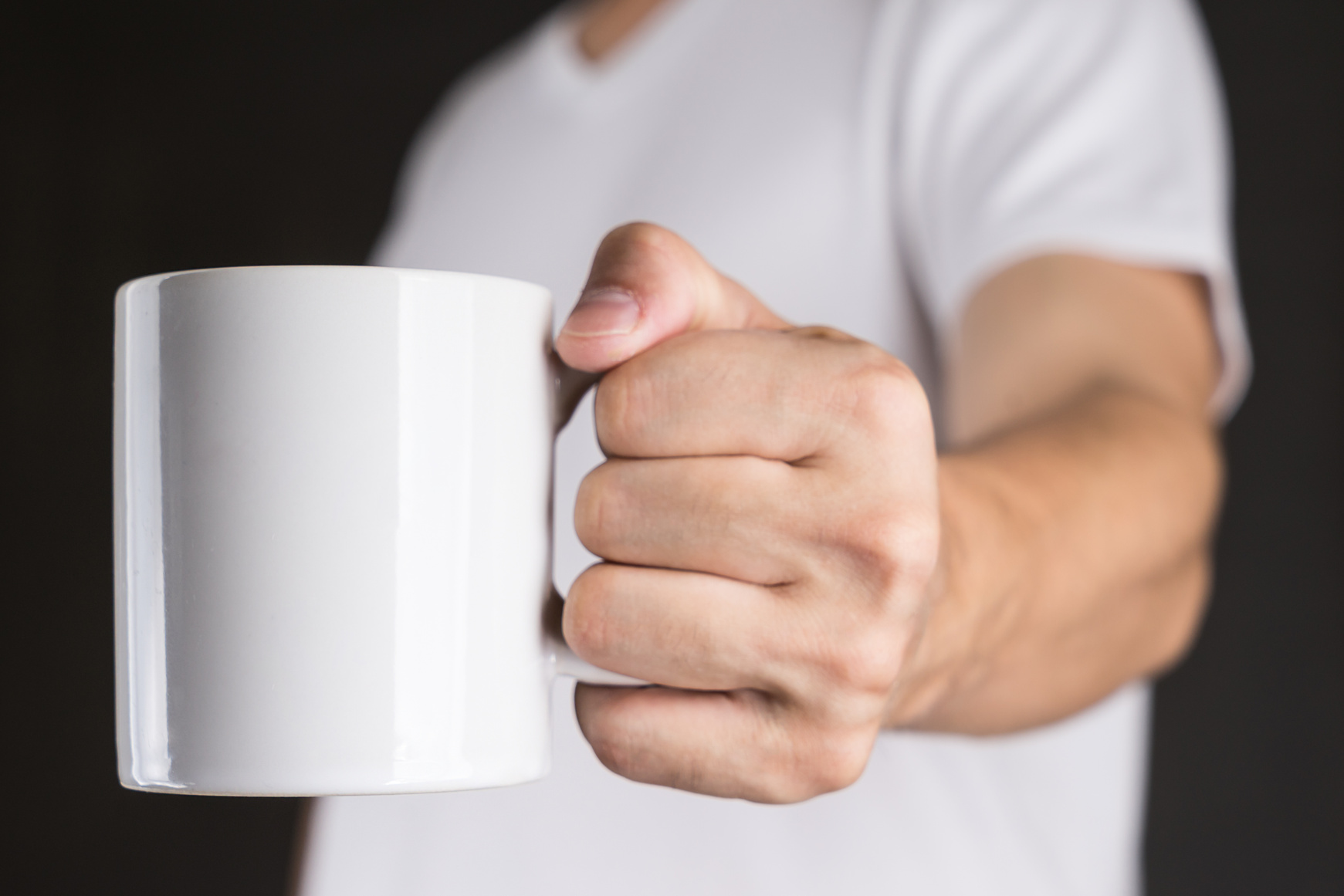 Man in White t-shirt holding Coffee mug